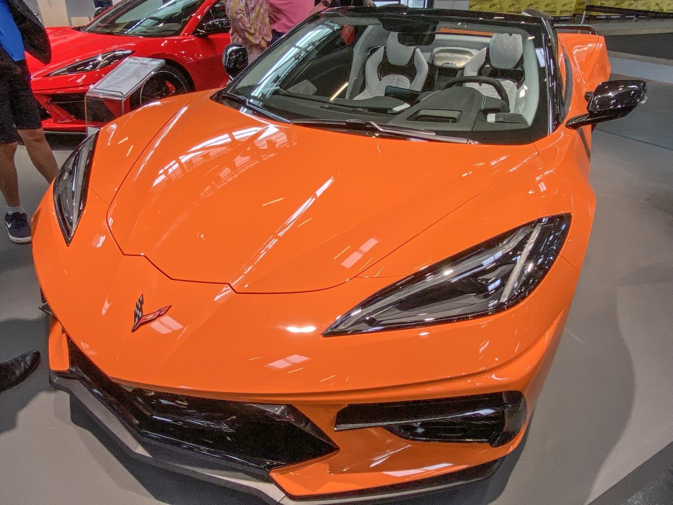 Bright orange sports convertible front view with sleek LED headlights