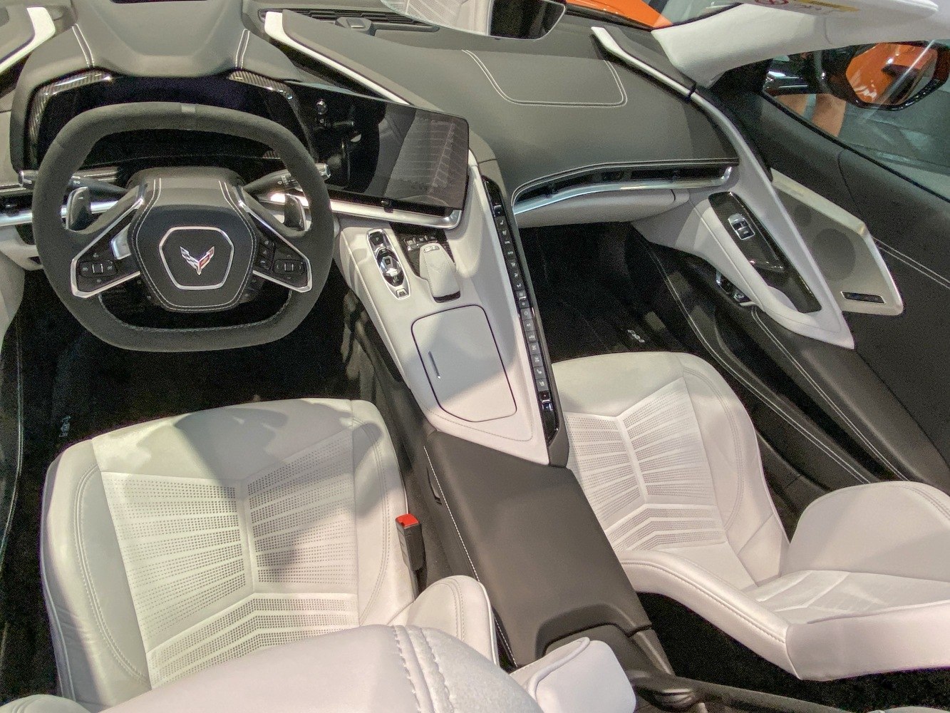 Modern interior with digital dashboard and white leather seats