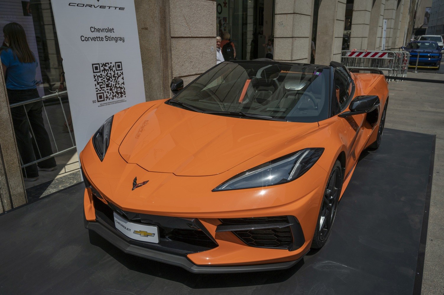 Front view of orange convertible sports car with sleek headlights