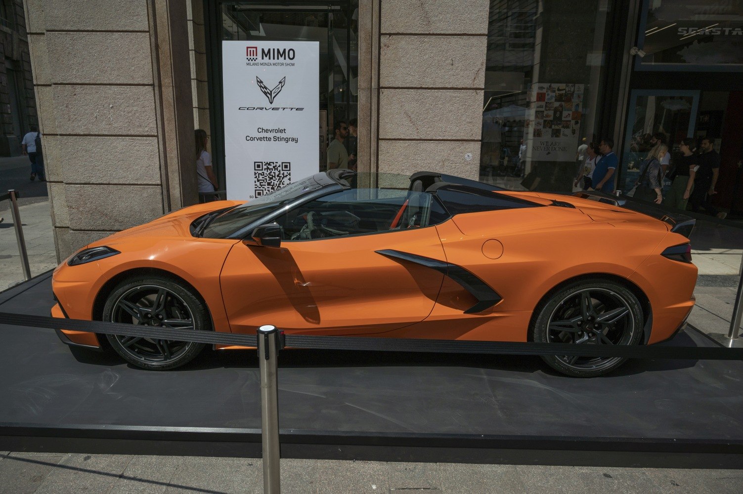 Orange convertible sports car with sleek aerodynamic side profile and black wheels