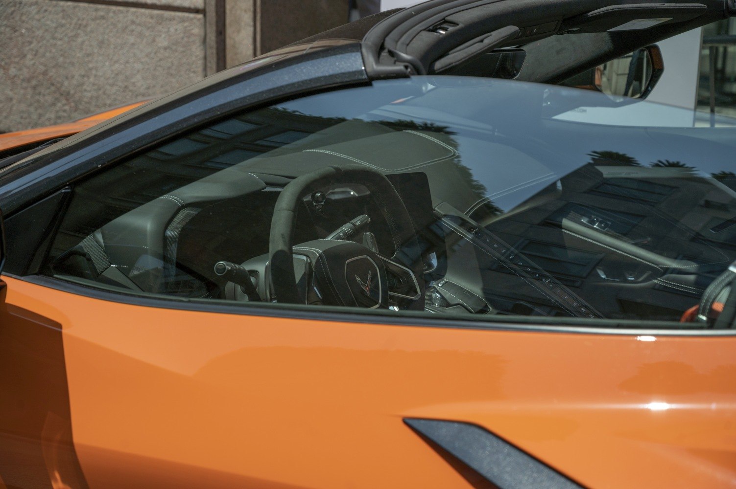 Close-up of steering wheel and dashboard in convertible sports car interior