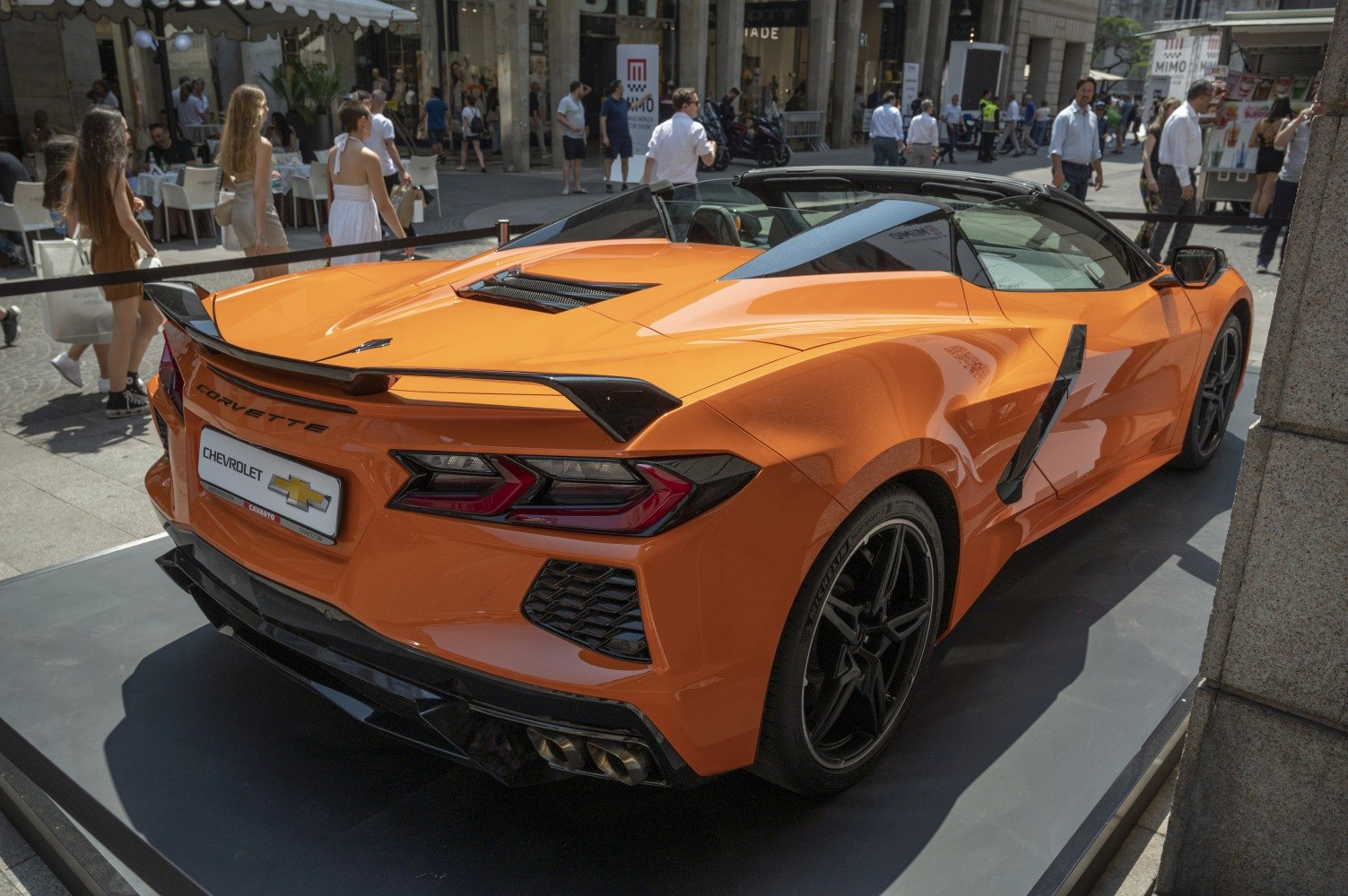 Rear design with spoiler and quad exhaust on a convertible sports car.