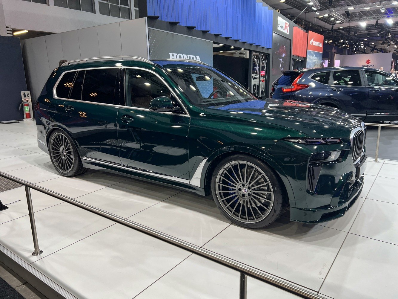 Luxury SUV with multi-spoke wheels and sleek glossy body