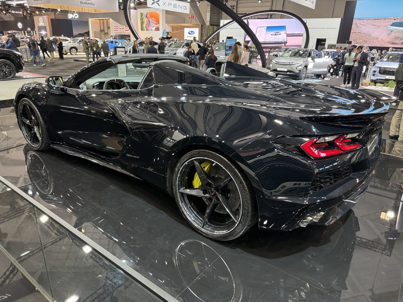 Rear and side view of a sleek convertible sports car with aerodynamic design and distinctive tail lights