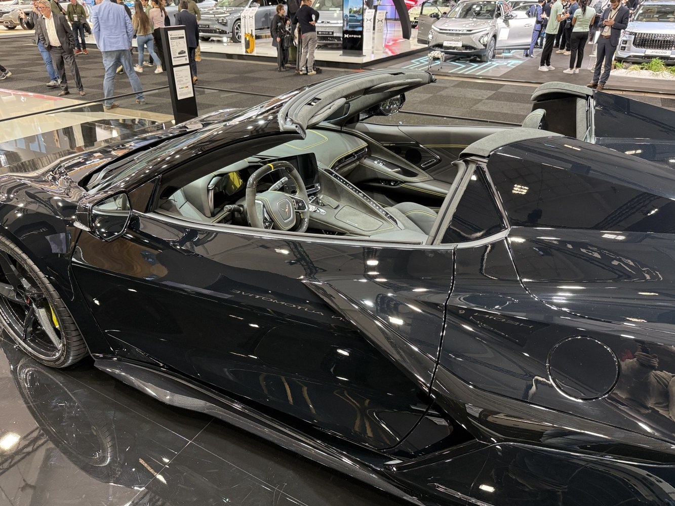Convertible sports car with black aerodynamic exterior and modern interior