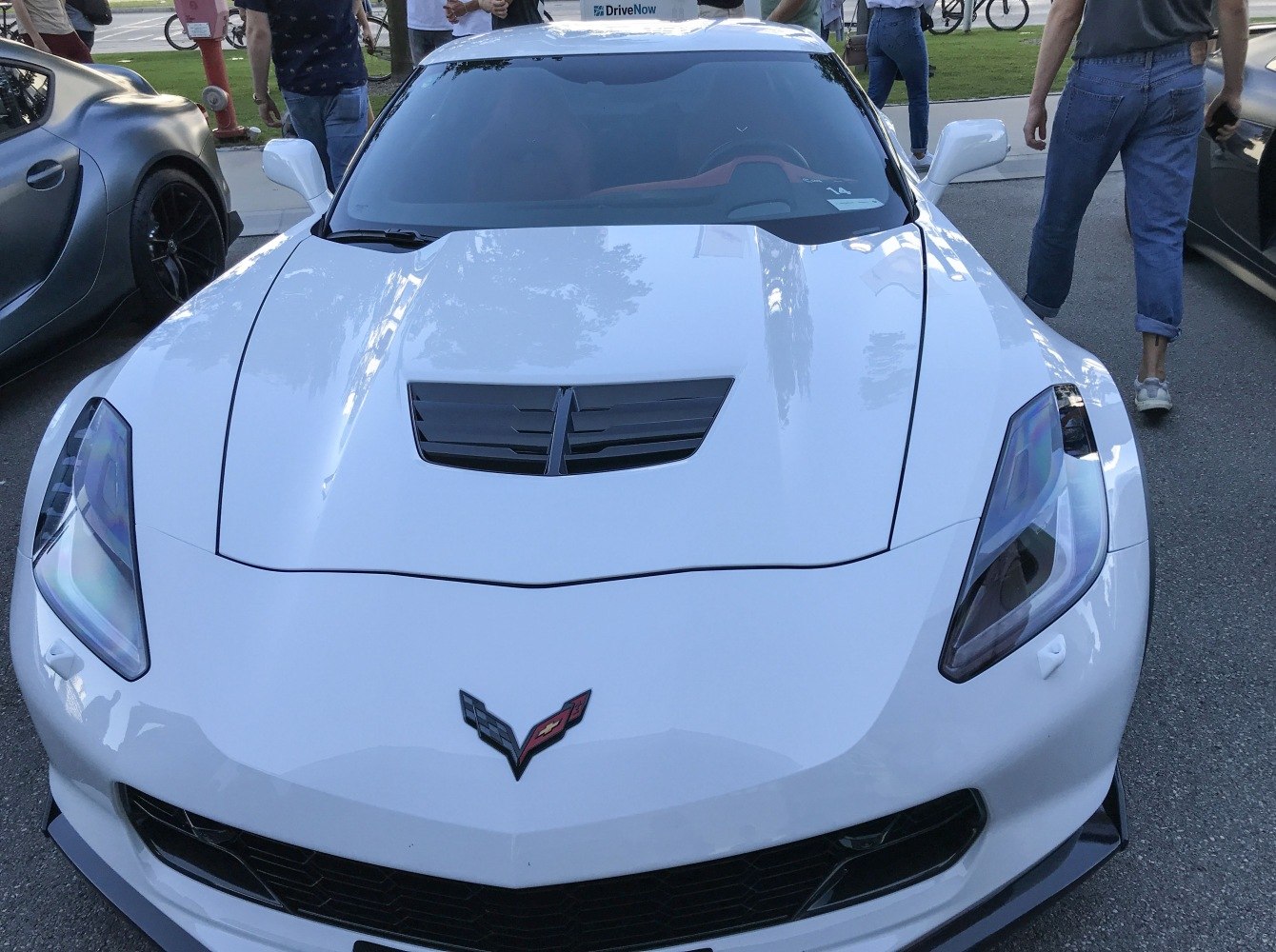 Front view showing hood vent and sleek headlights of a sports coupe