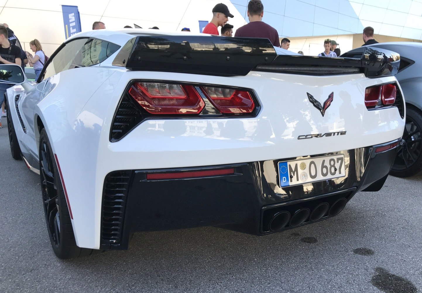 Rear view with quad exhausts, angular taillights, and rear spoiler