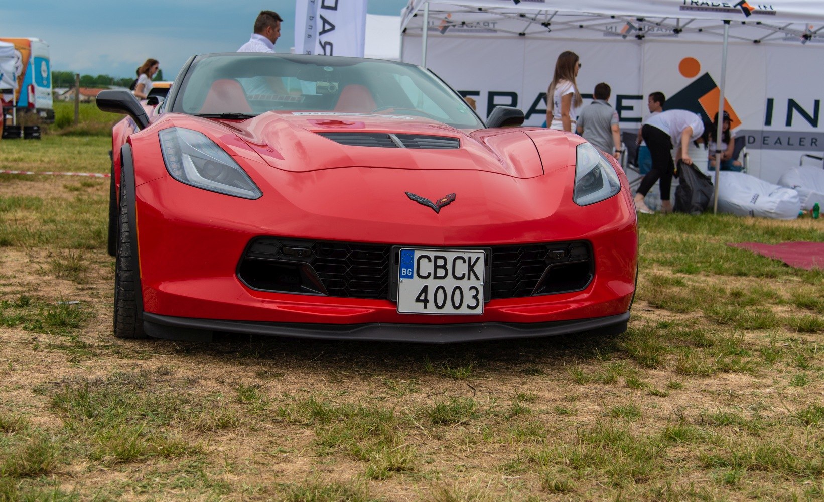 Front close-up of sports car with sleek headlights and wide grille
