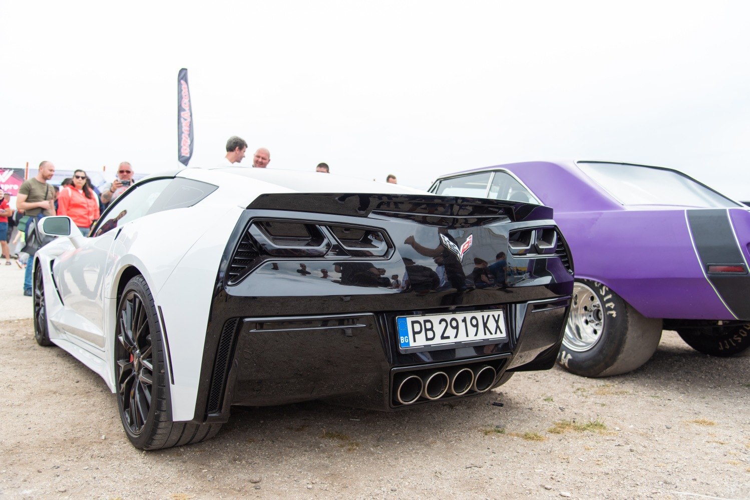 Rear view featuring quad exhaust pipes and black rear fascia with taillights