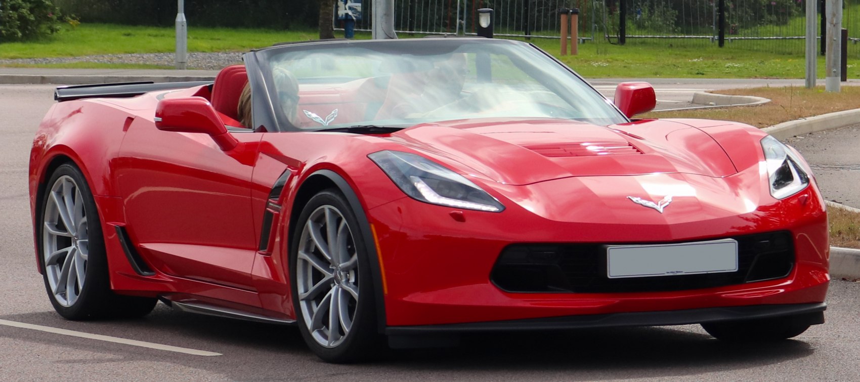 Red convertible with sharp headlights and aerodynamic front design