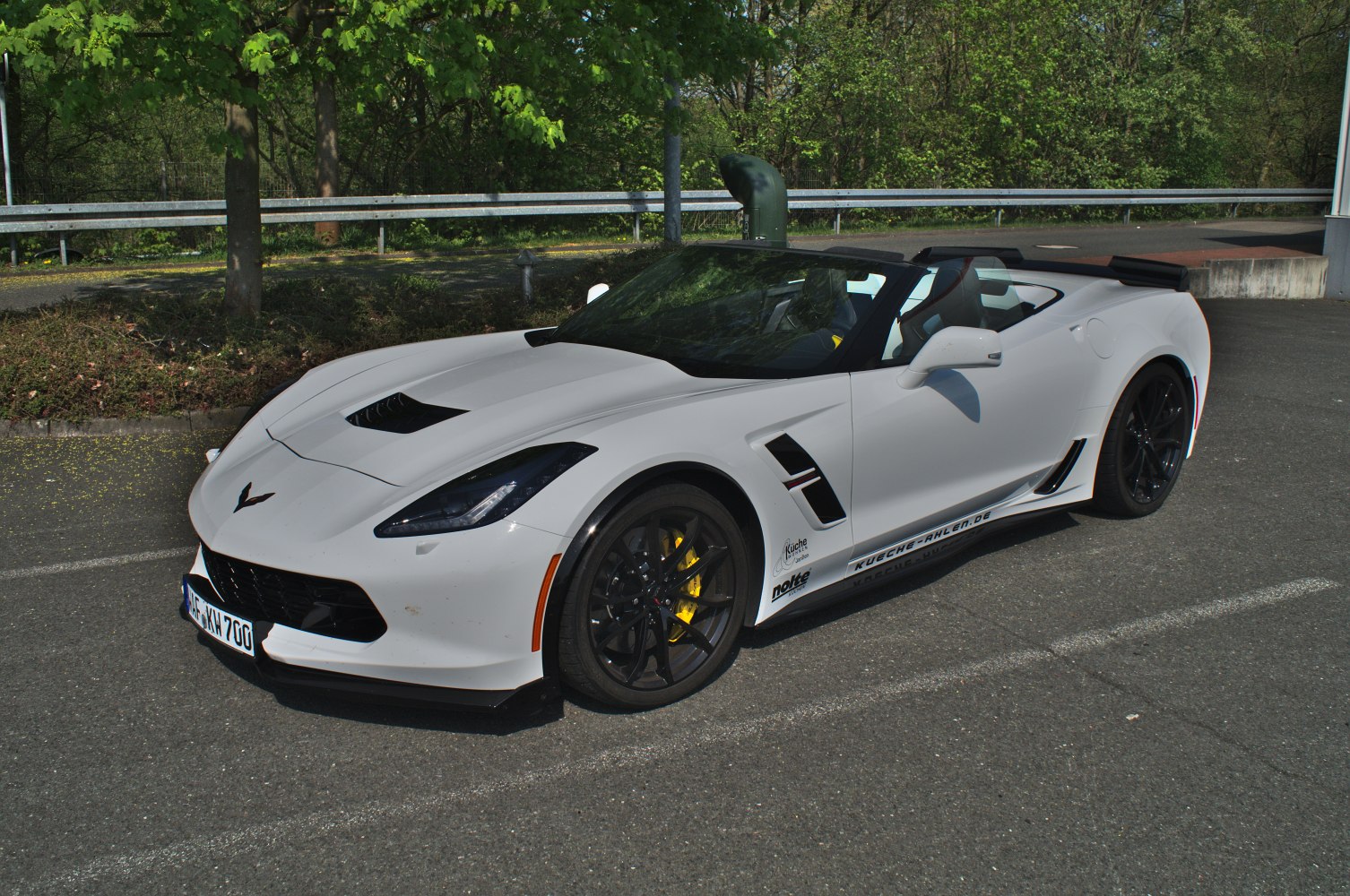 White convertible with black wheels and yellow brake calipers