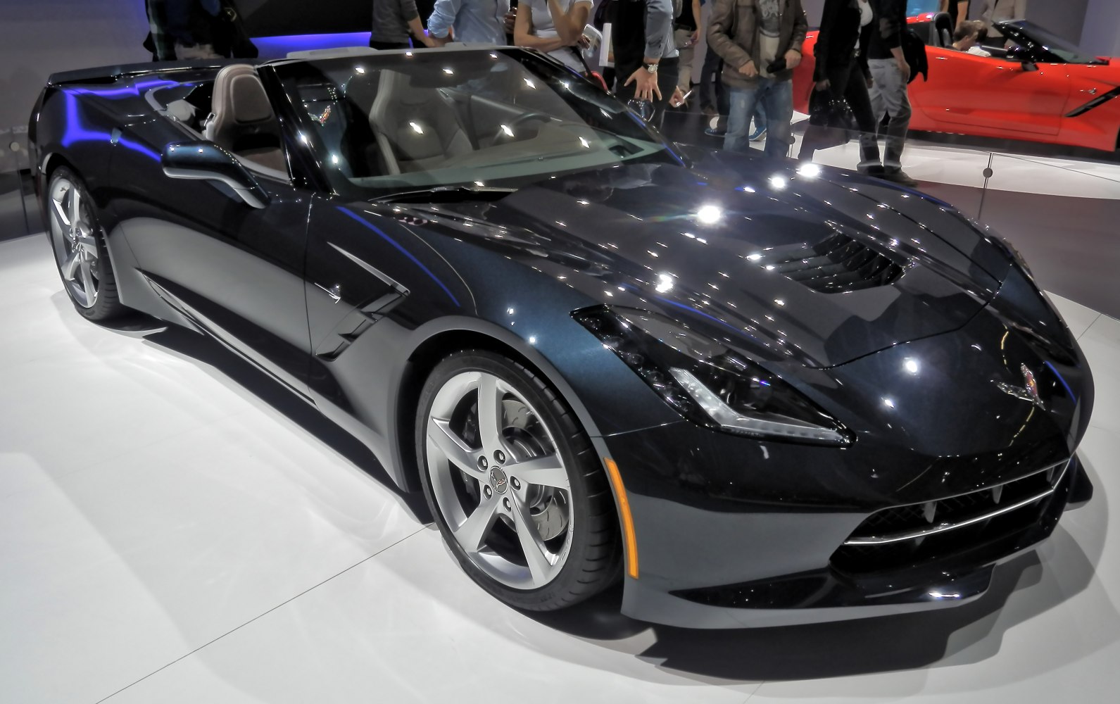 Sleek black convertible with aerodynamic front and alloy wheels