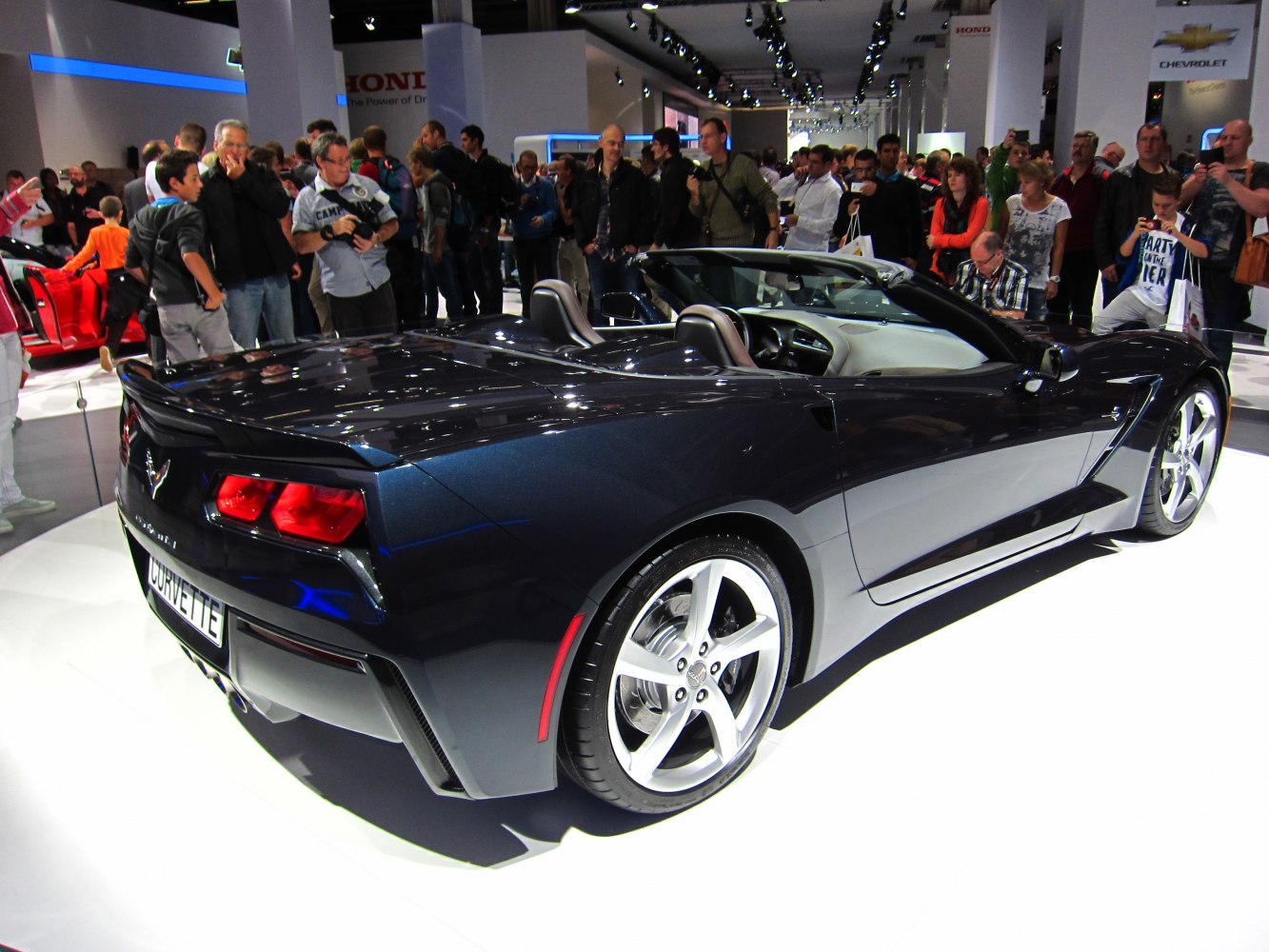 Rear three-quarter view of a convertible sports car with distinctive taillights and alloy wheels.