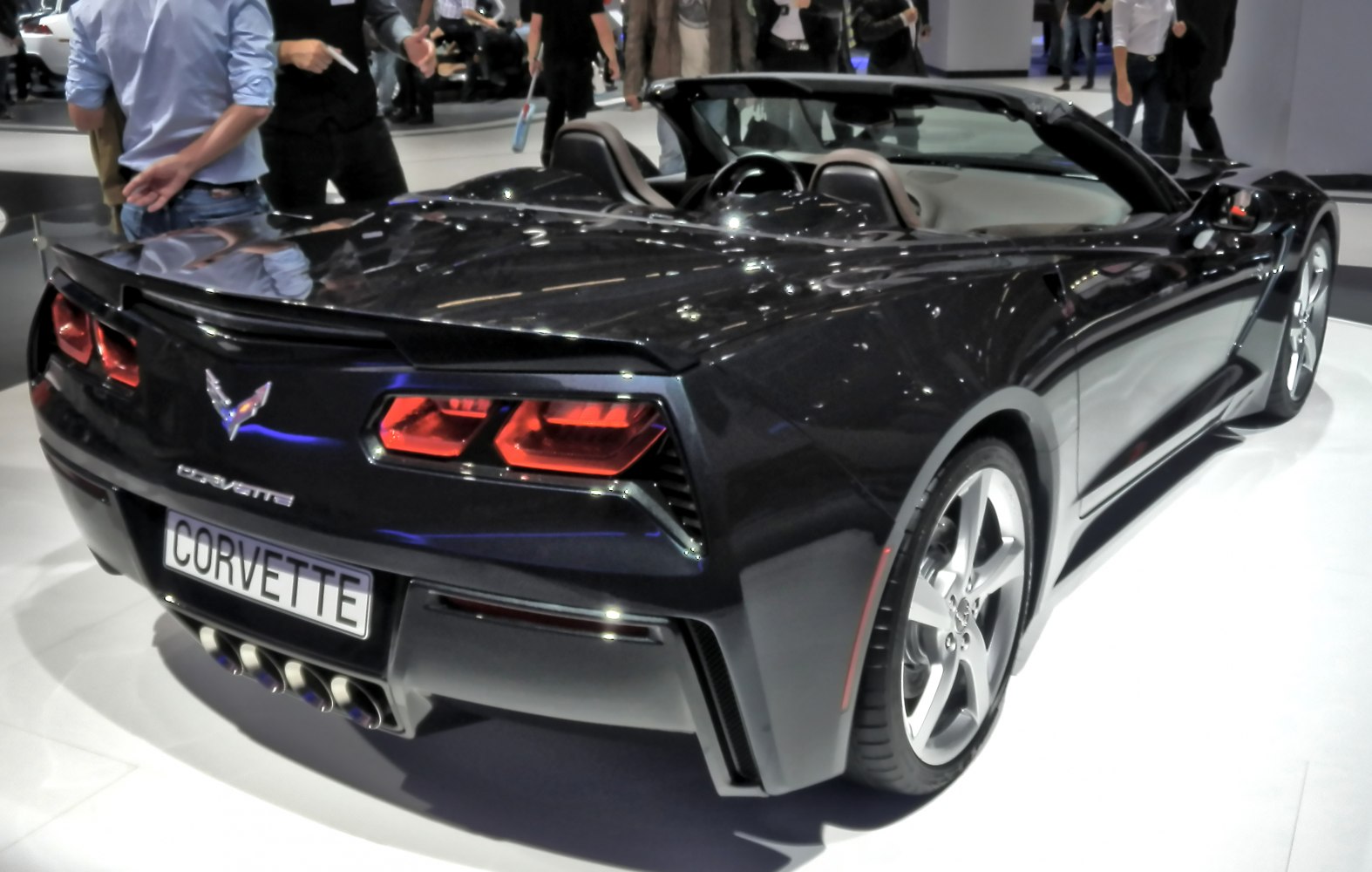 Convertible sports car rear with quad exhausts and LED taillights