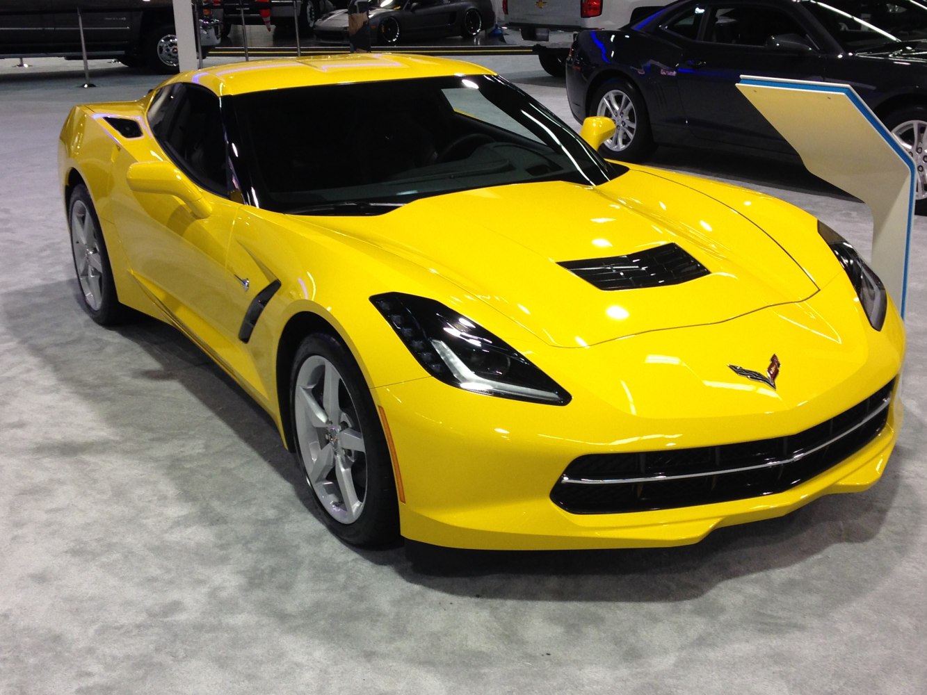 Yellow sports coupe with distinct front hood vent and aerodynamic styling