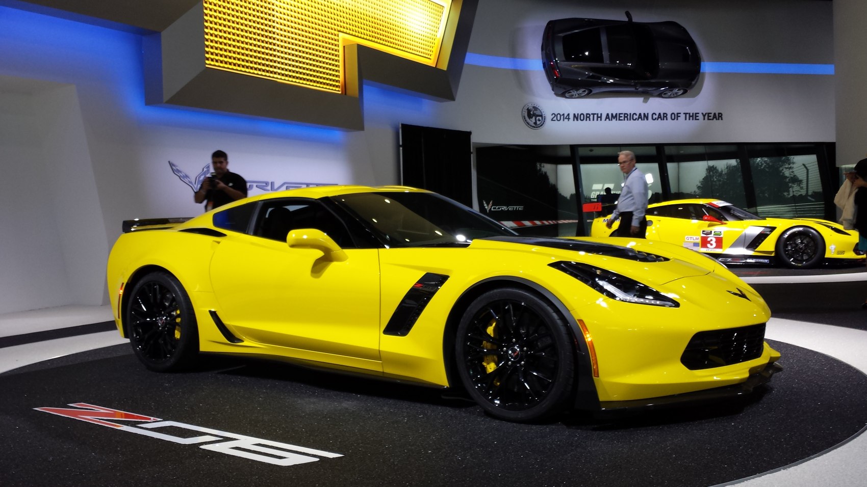 Yellow sports coupe with black rims and aggressive aerodynamics