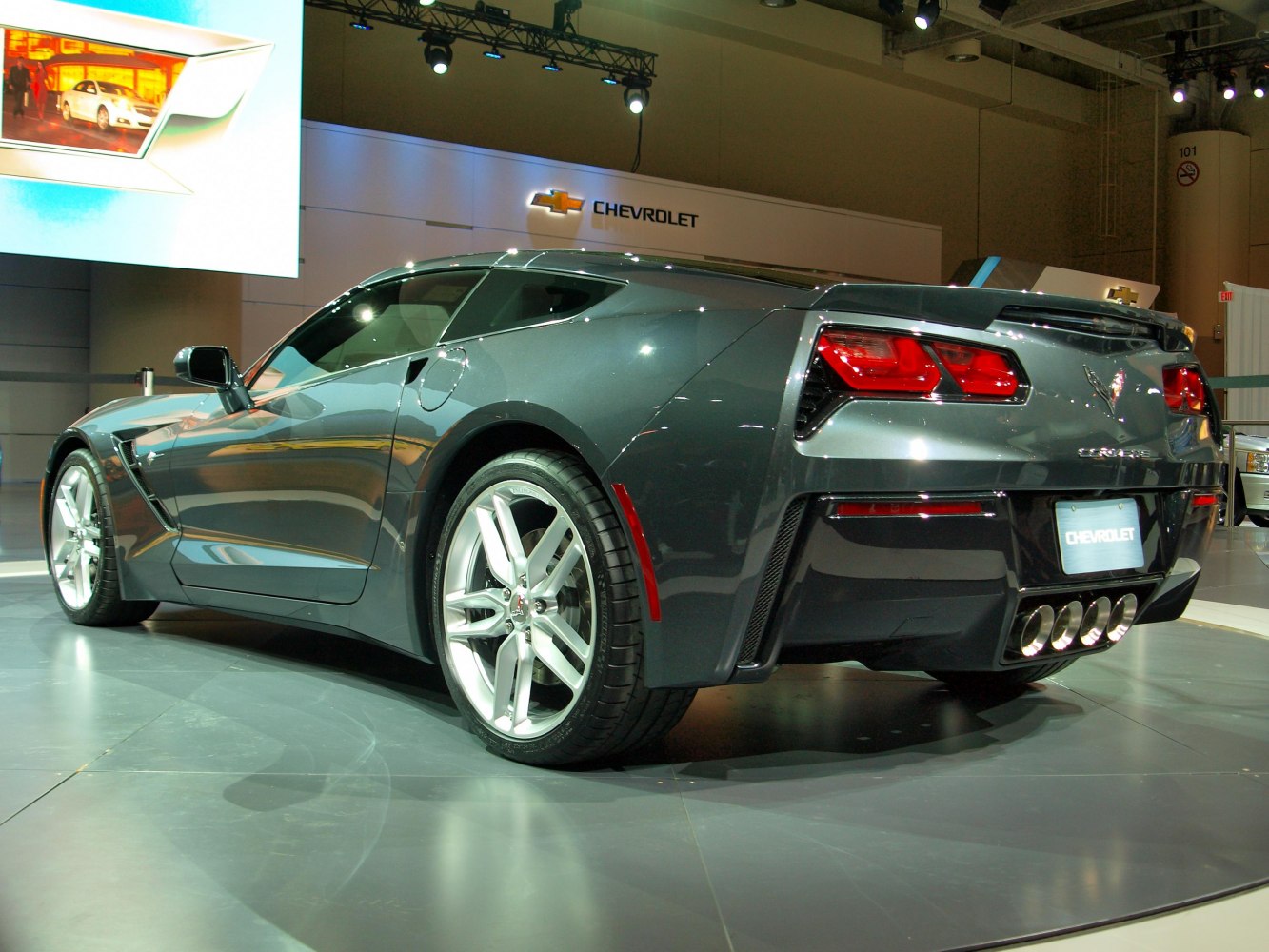 Rear view of sleek coupe with quad exhaust and distinctive taillights
