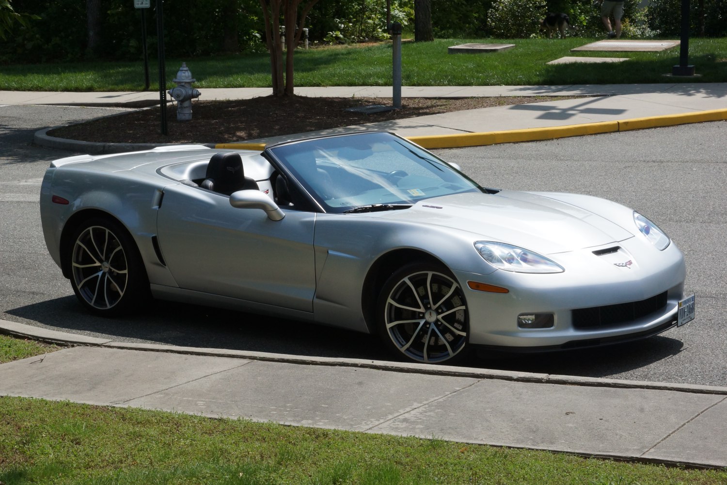 Silver sports convertible with sleek side profile and sporty rims