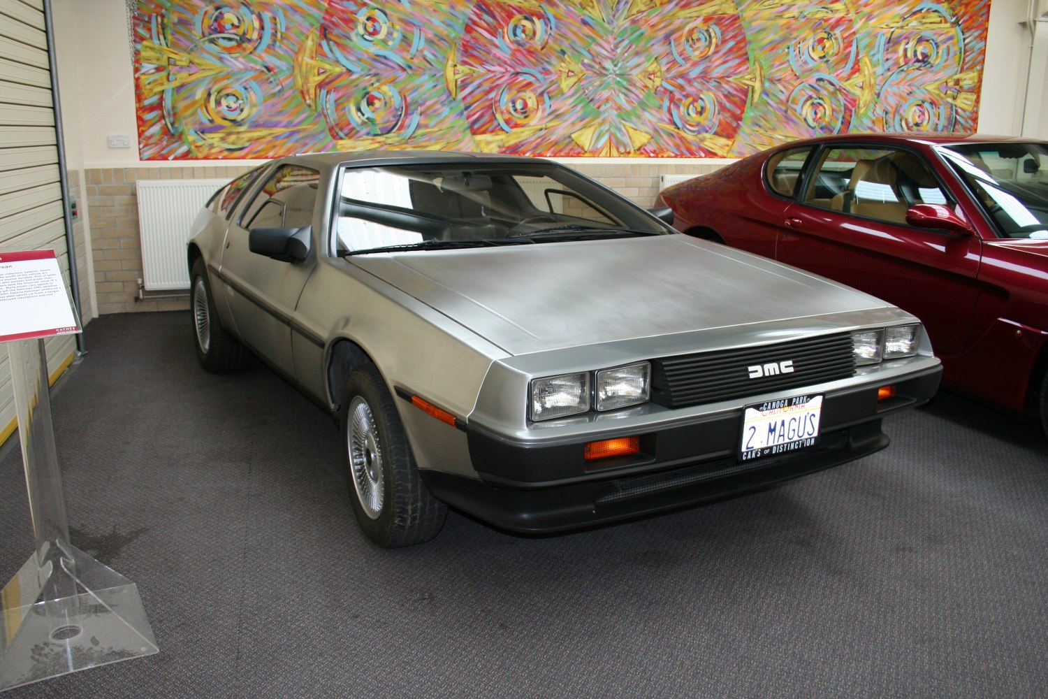 Stainless steel sports coupe front end with rectangular headlights.
