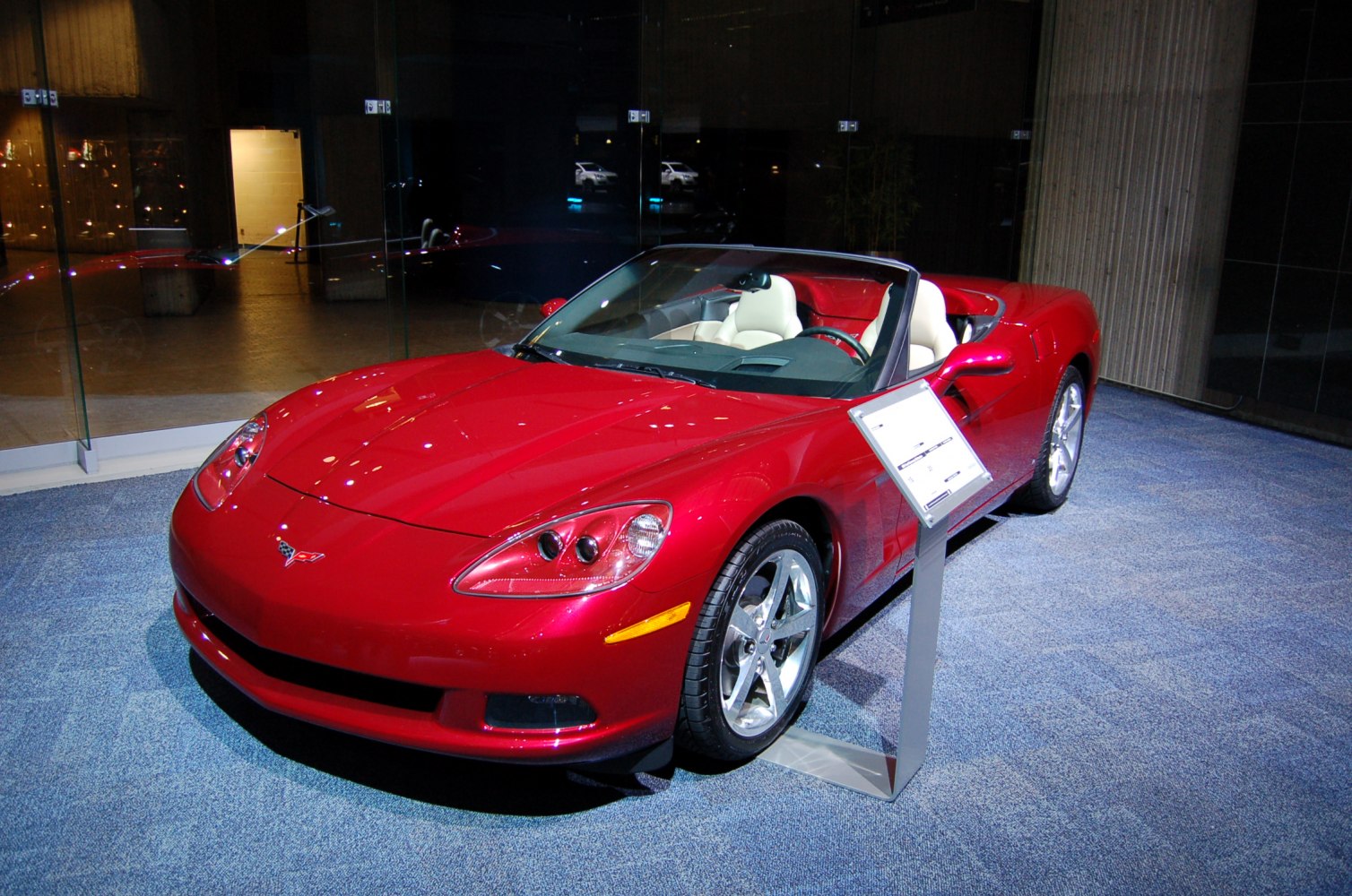 Red convertible sports car with sleek aerodynamic design and silver alloy wheels