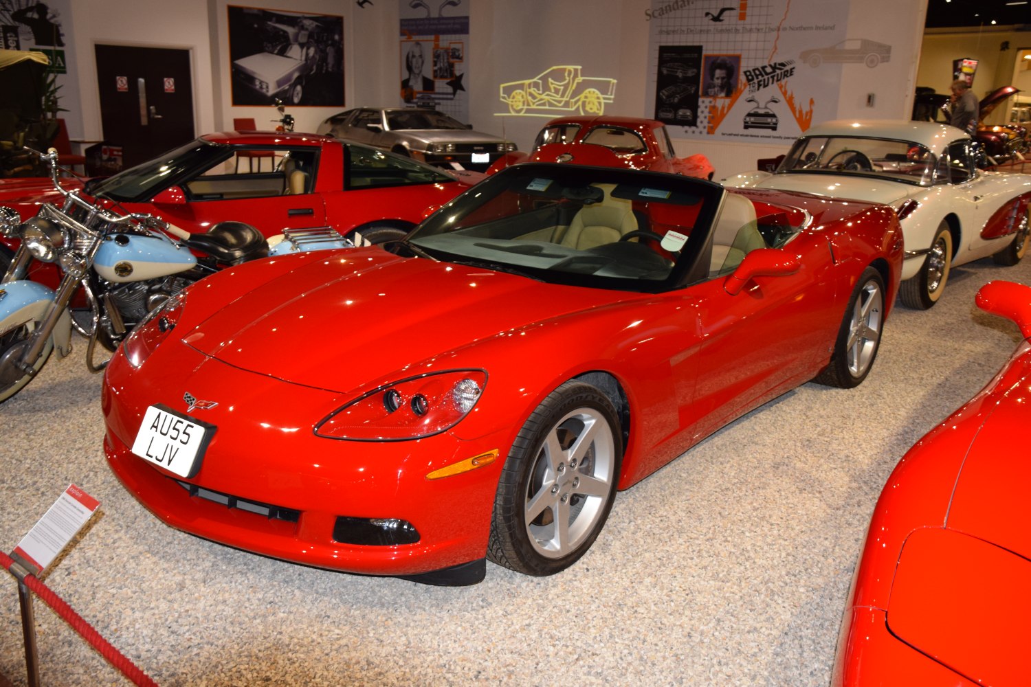 Red convertible sports vehicle with sleek body and alloy wheels