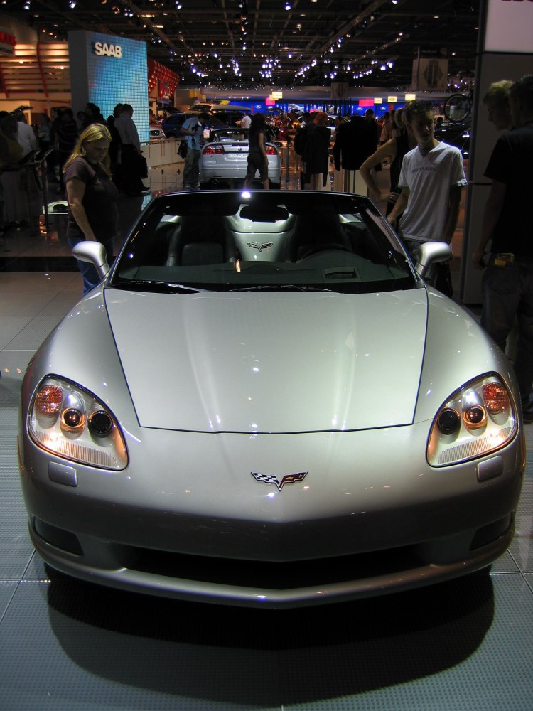 Front view of a sleek convertible with distinct headlights and emblem.