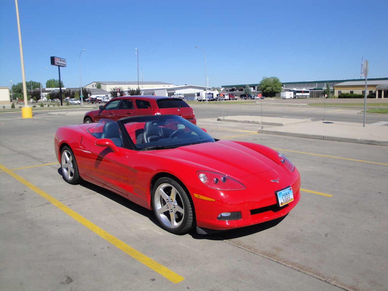 Red convertible sports car with sleek front and alloy wheels