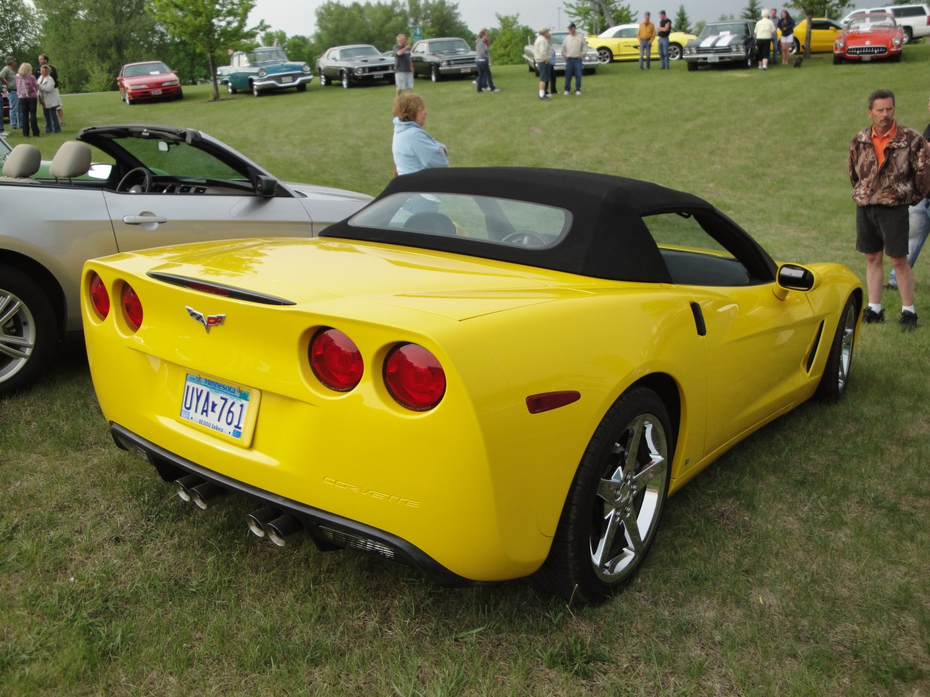 Rear view of a yellow convertible with quad exhaust and round taillights