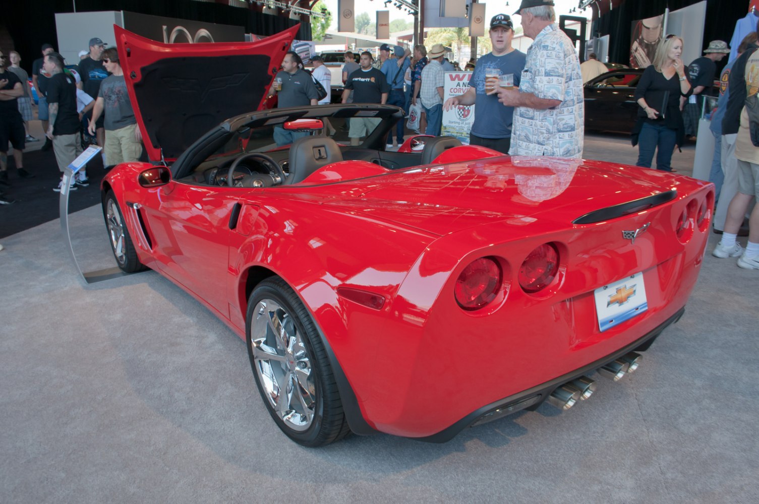 Red convertible rear view with open hood and dual exhaust