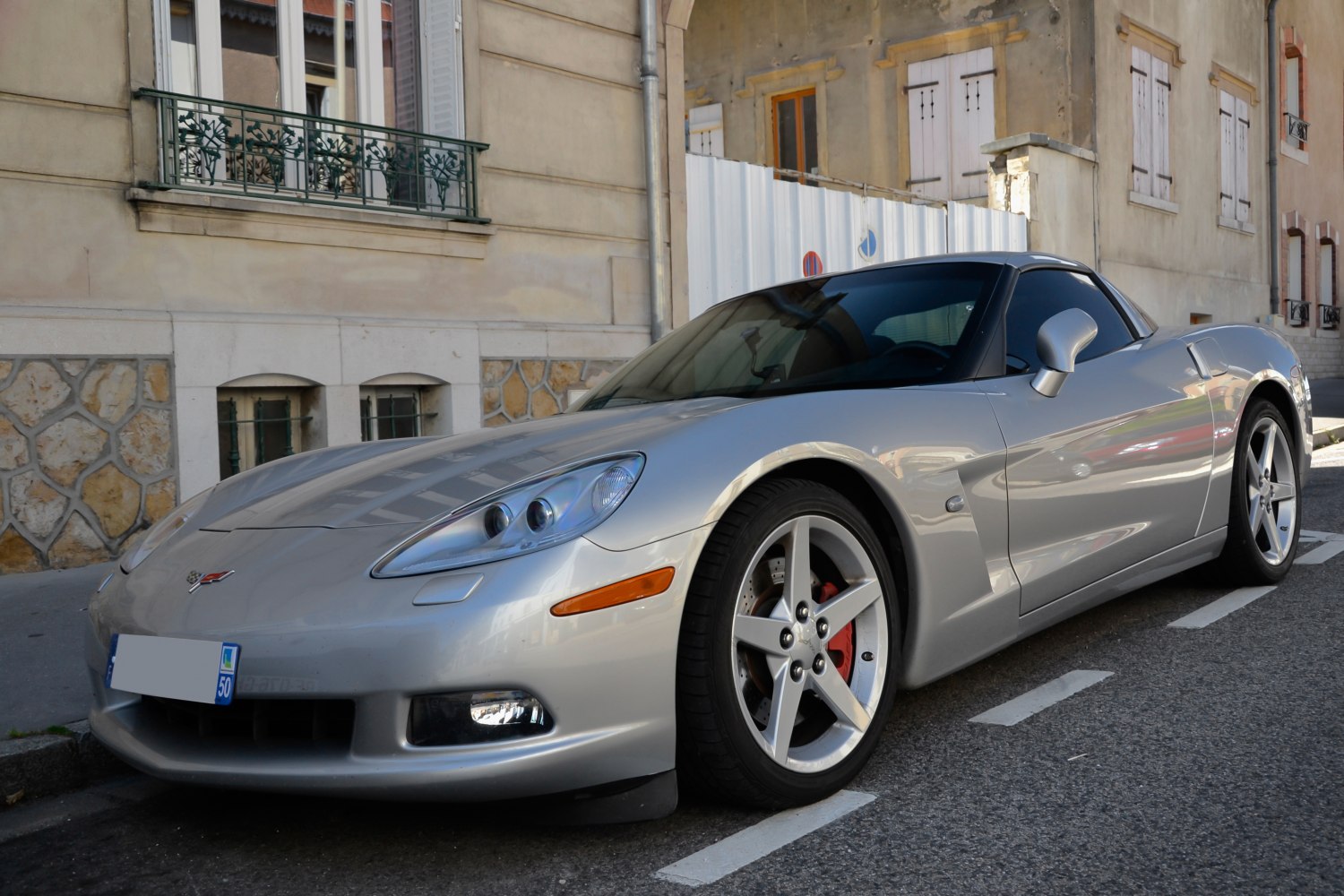 Silver coupe with distinctive headlights and five-spoke alloy wheels
