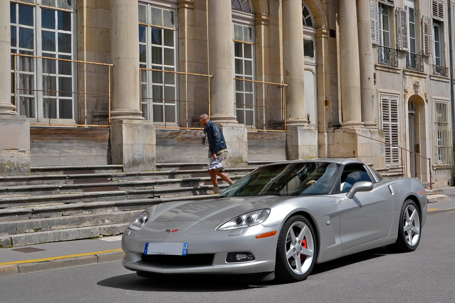 Silver sleek sports coupe with red brake calipers