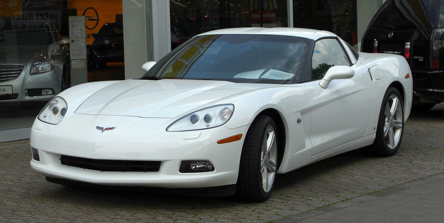 White sports coupe with distinct headlights and aerodynamic front design