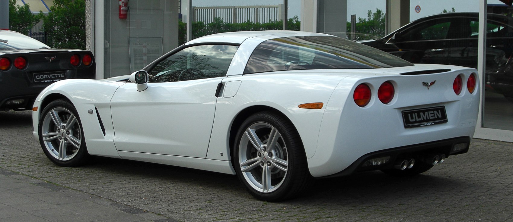 White sports coupe with quad exhaust and round tail lights