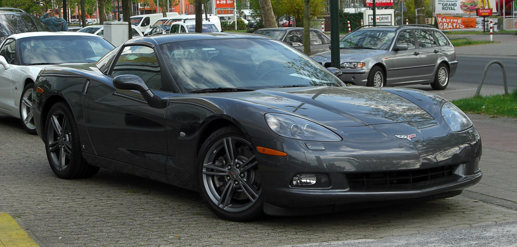 Sleek aerodynamic front side view with signature headlights and alloy wheels