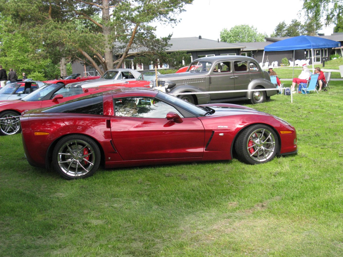 Red sports coupe with chrome wheels and red brake calipers