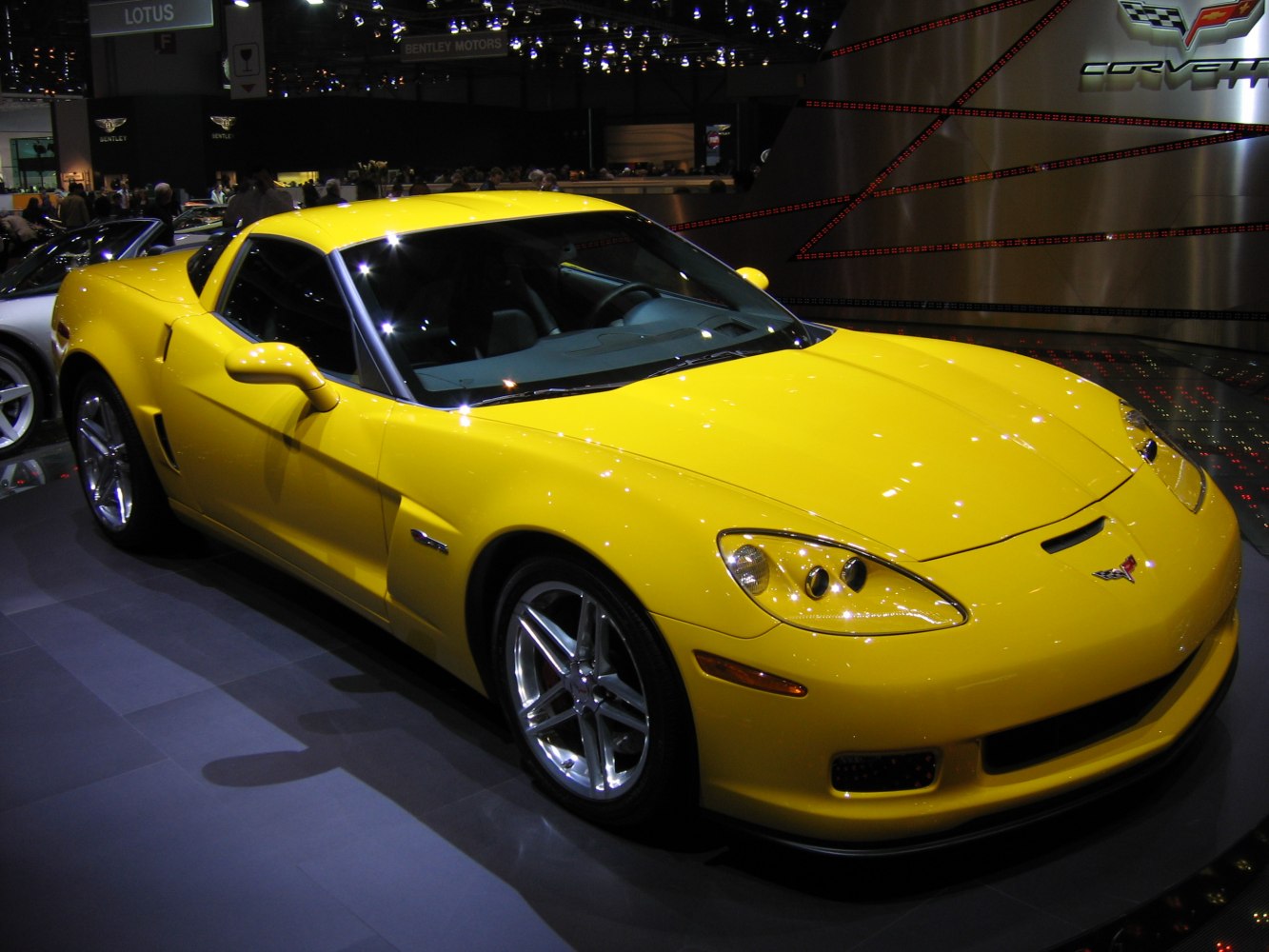 Yellow sports coupe with front headlights and side profile