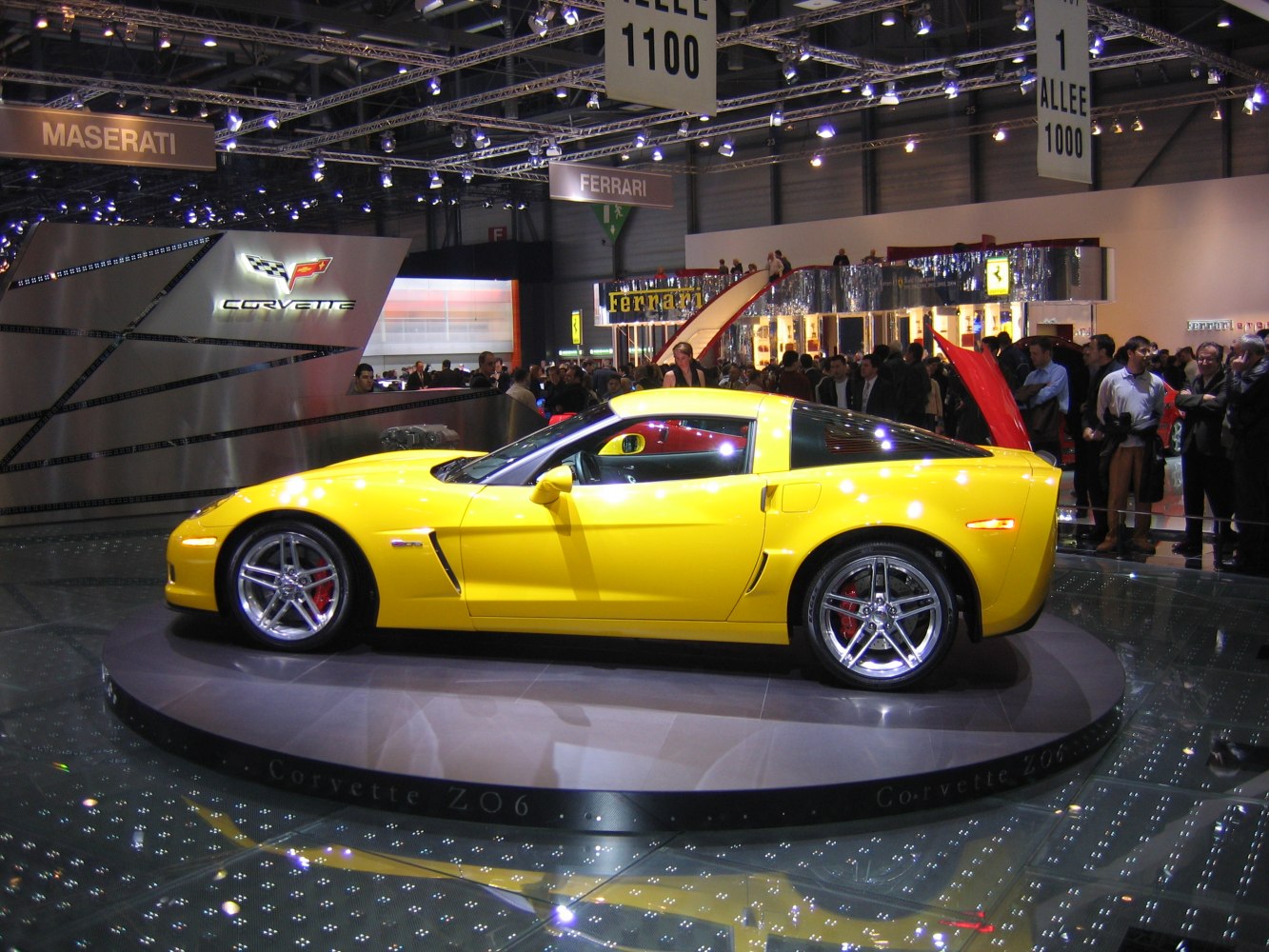 Yellow sports coupe on rotating display platform