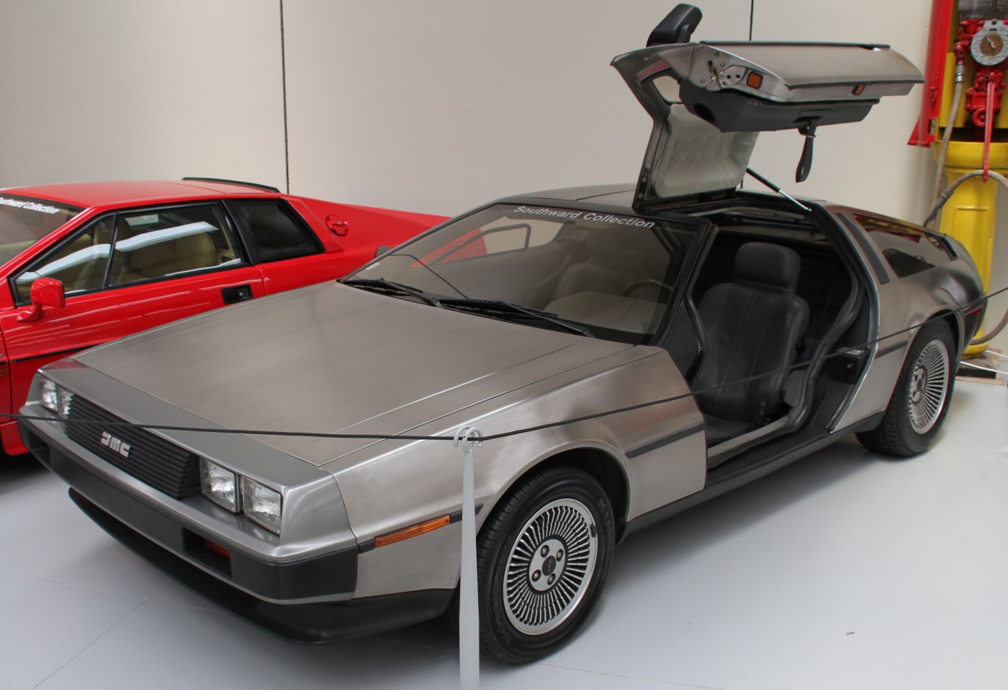Gullwing doors, brushed stainless steel body, vintage sports car exterior