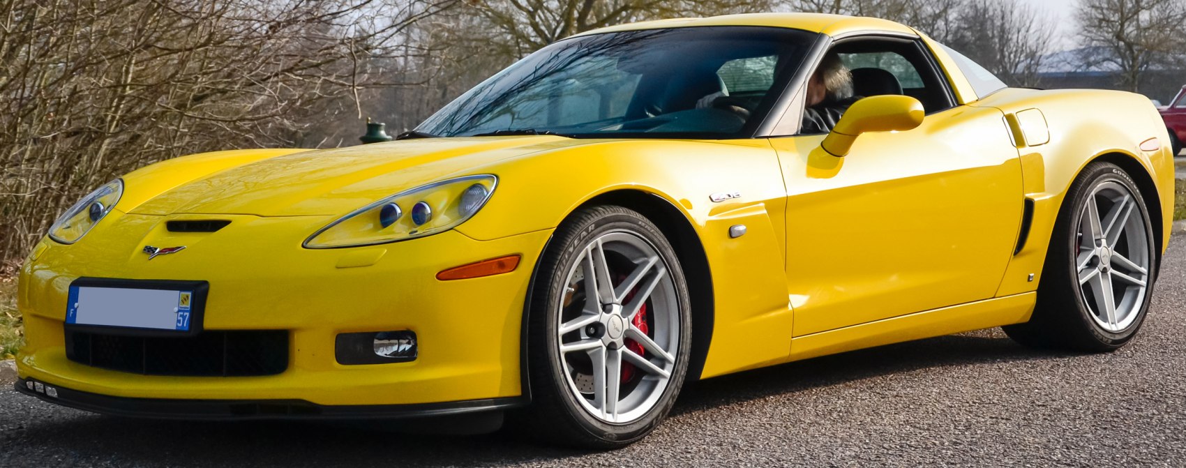Yellow sports coupe with sleek front and side profile, alloy wheels, and aerodynamic design