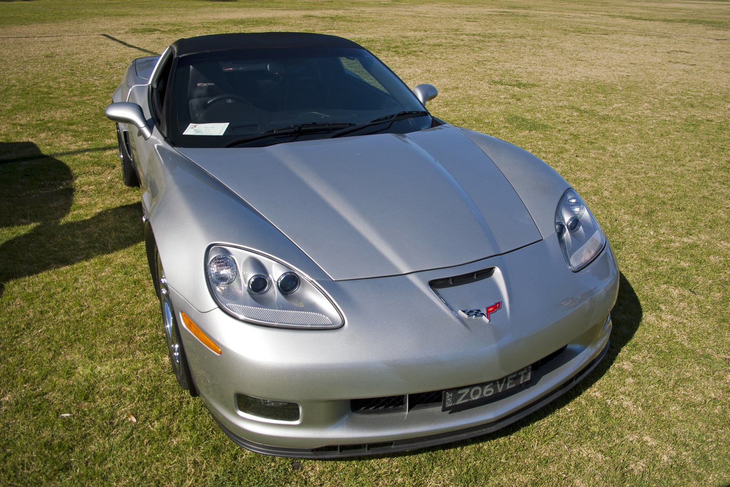 Silver sports coupe front with distinct headlights and emblem