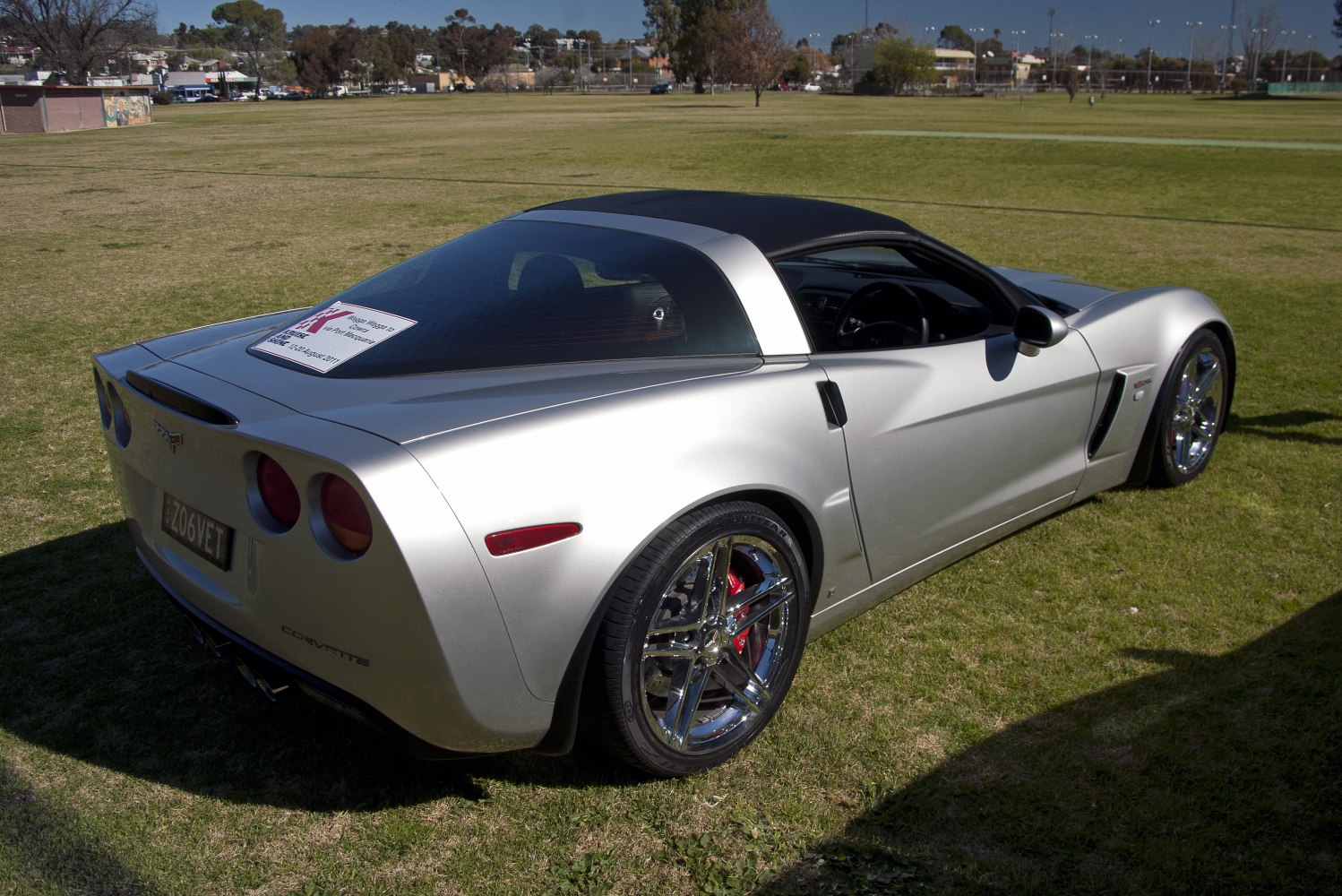 Rear and side of silver coupe with chrome wheels and distinct taillights