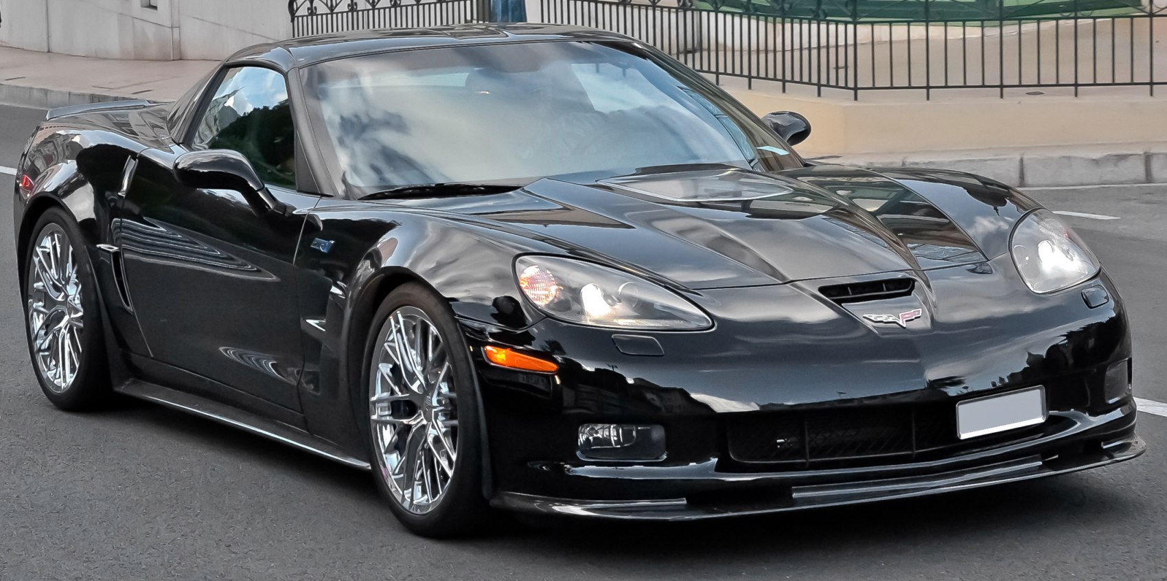 Sleek black sports coupe with aerodynamic curves and chrome rims