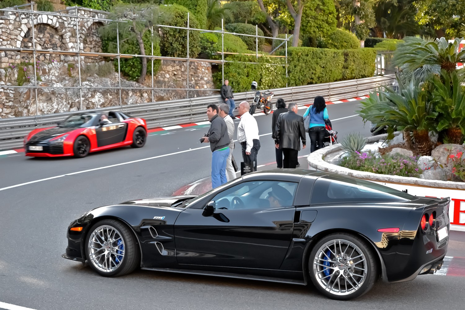 Black sports coupe with alloy wheels on race track corner