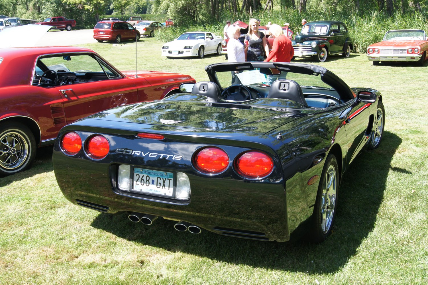 Rear view of a convertible with quad exhaust and round taillights