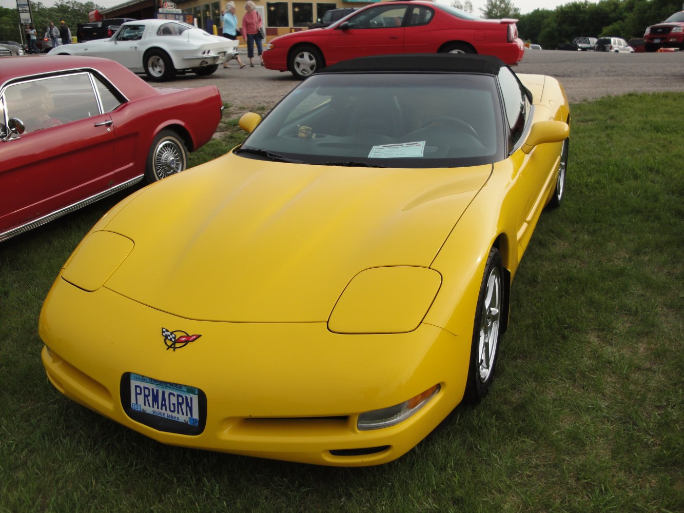 Yellow convertible with pop-up headlights and aerodynamic front design