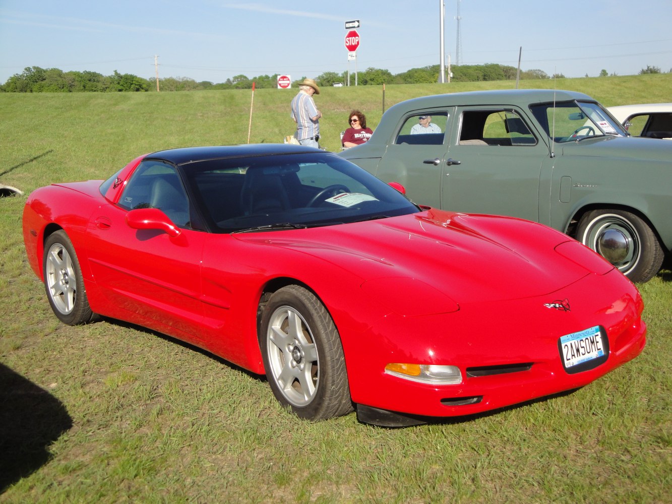 Red sports coupe with black roof and sleek aerodynamic design
