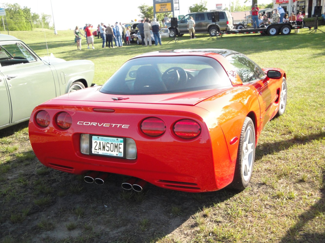 Rear view of a coupe with quad exhaust and rounded tail lights