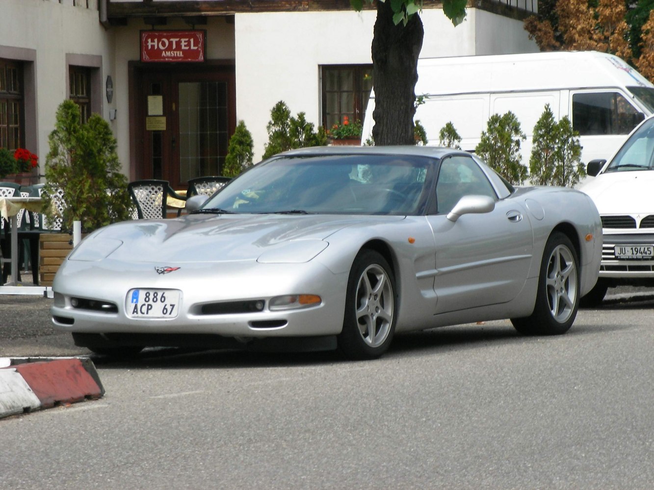 Silver sports coupe with aerodynamic body and pop-up headlights