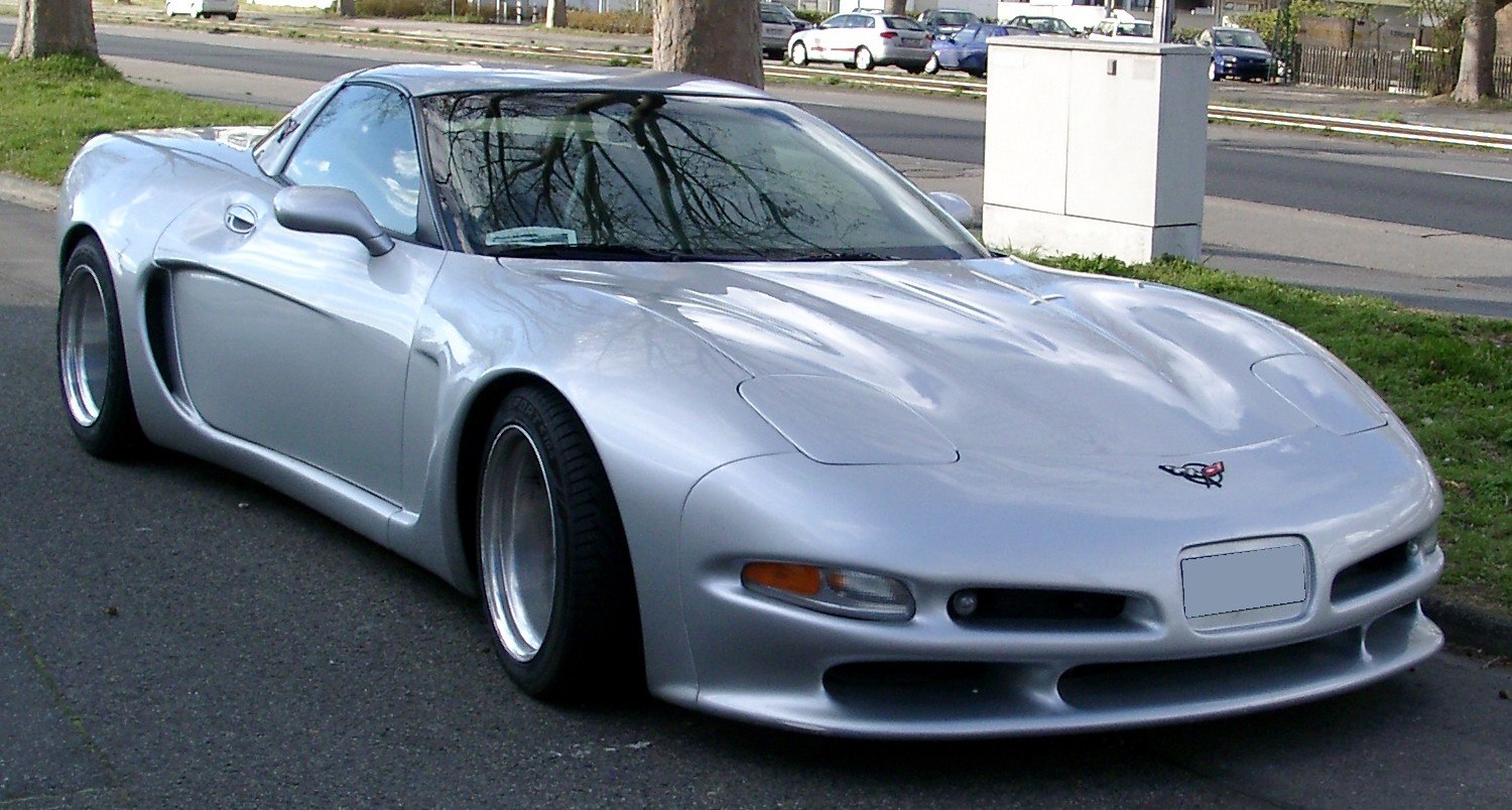Silver sports coupe with wide wheels and low front air intake