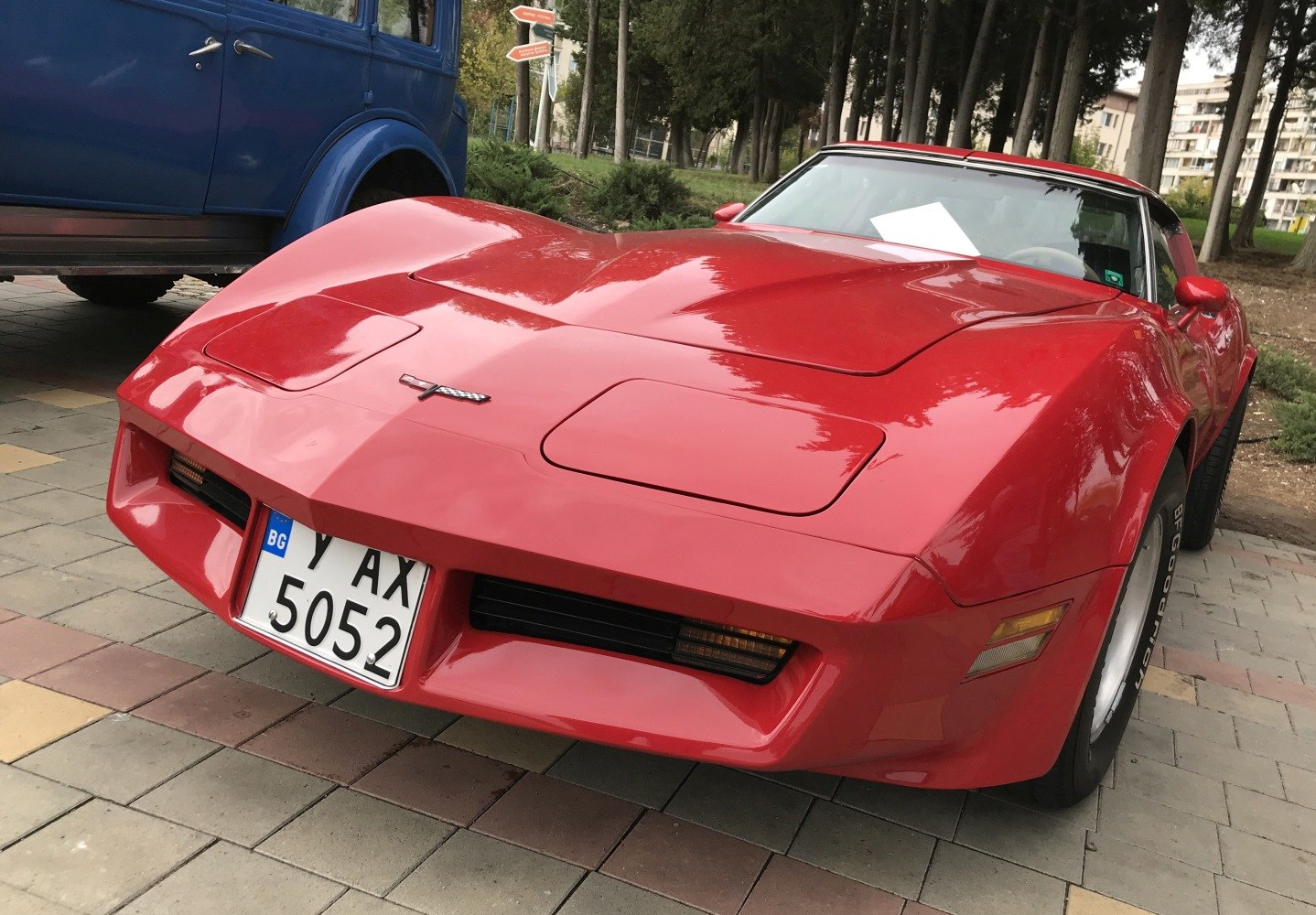 Front view with hood, pop-up headlights, and grille